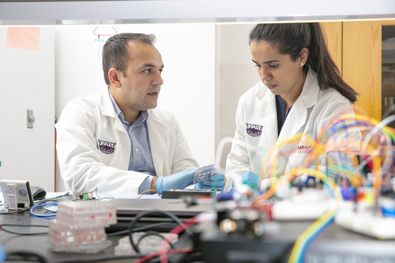 Sandhya Sharma, a Ph.D. student in FAU’s Department of Electrical Engineering and Computer Science and a research assistant in the Asghar Laboratory works with Waseem Asghar, Ph.D. 
