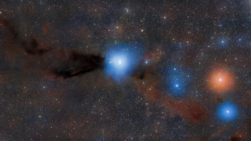 The two young, low-mass proto-stars HR 5999 and HR 6000 illuminate nearby dust, creating the reflection nebula Bernes 149. These stars grew out of the dusty dark cloud of Lupus 3, part of a larger complex of as many as nine dark clouds.